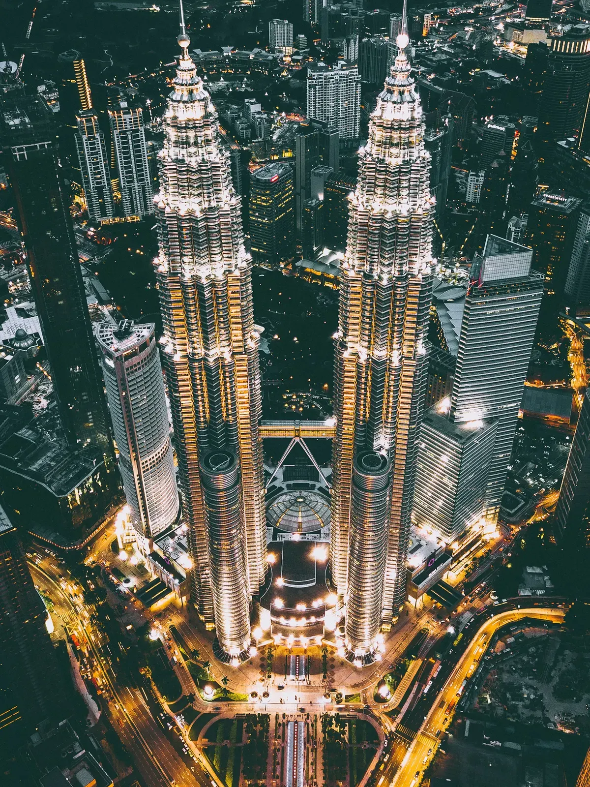 Aerial night view of the Petronas Twin Towers and the surrounding city