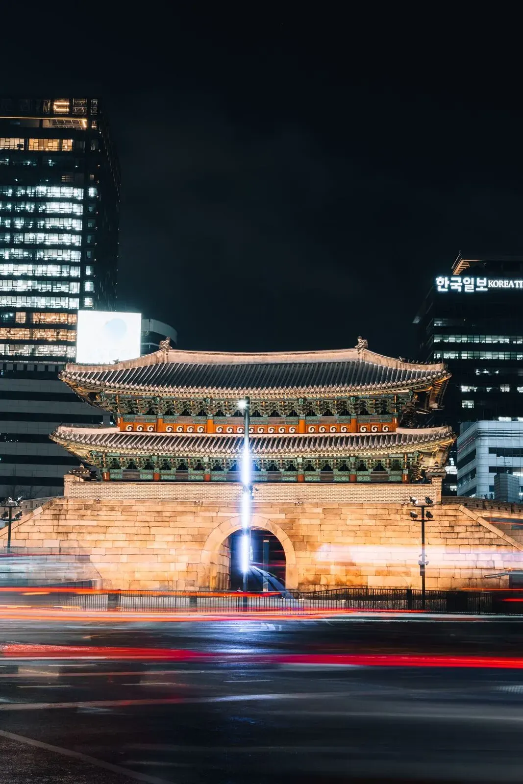 A traditional Korean gate lit at night