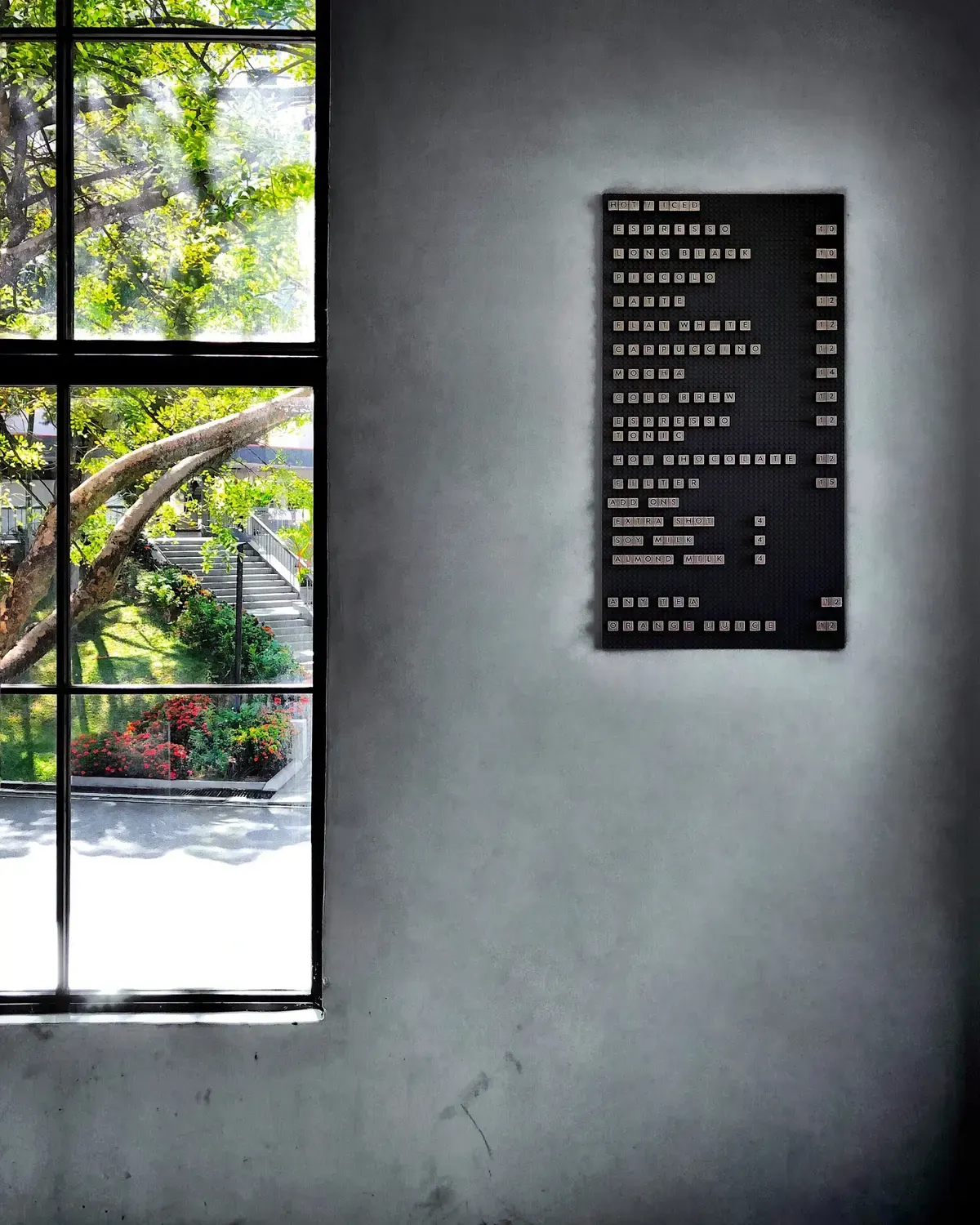 A calm café interior in Mont Kiara, with a window onto greenery