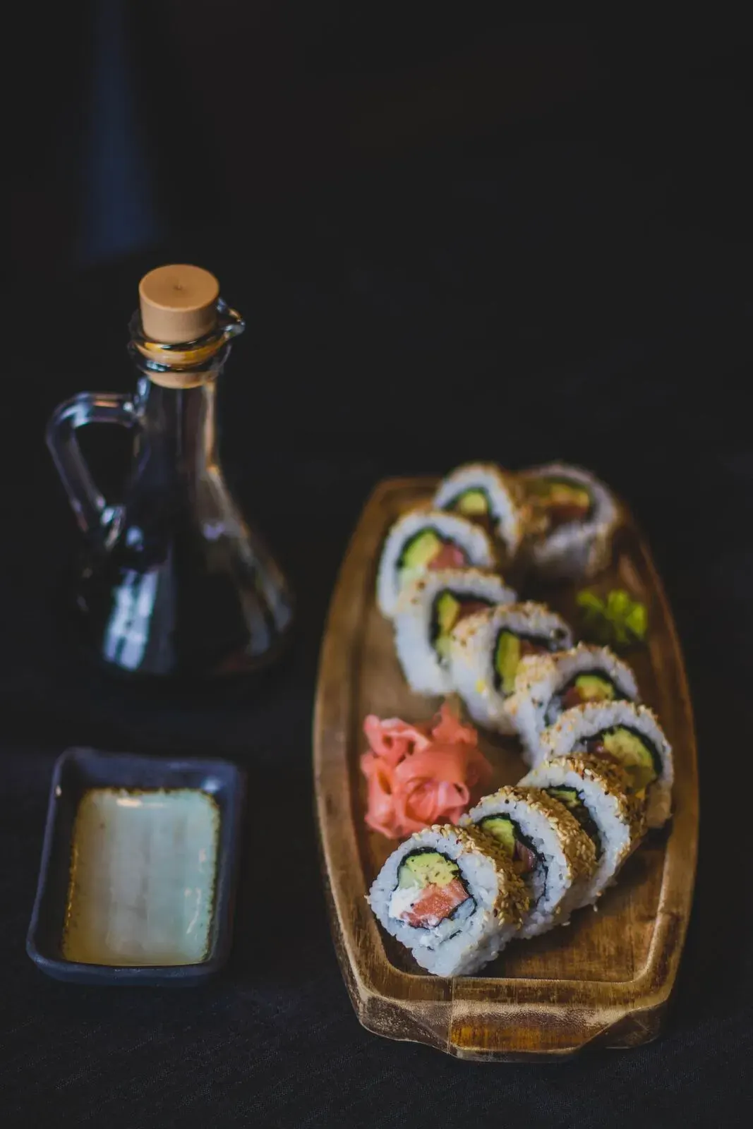 A sushi platter on a dark table