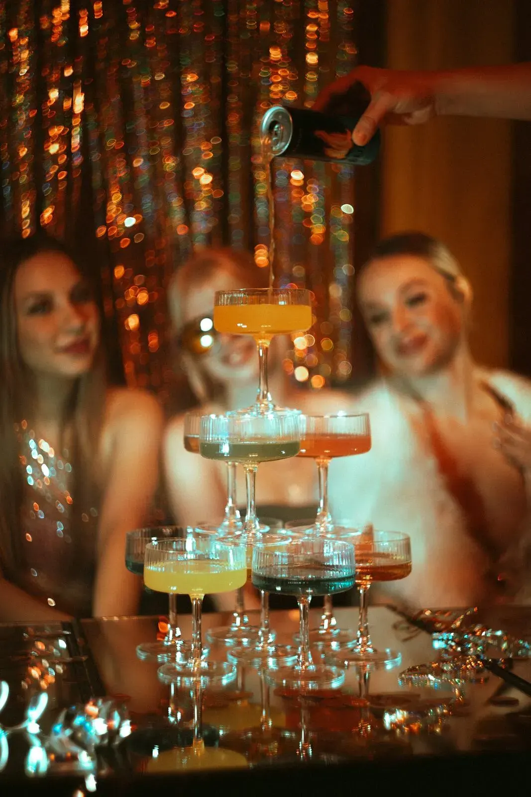 Guests talking over drinks at an evening table